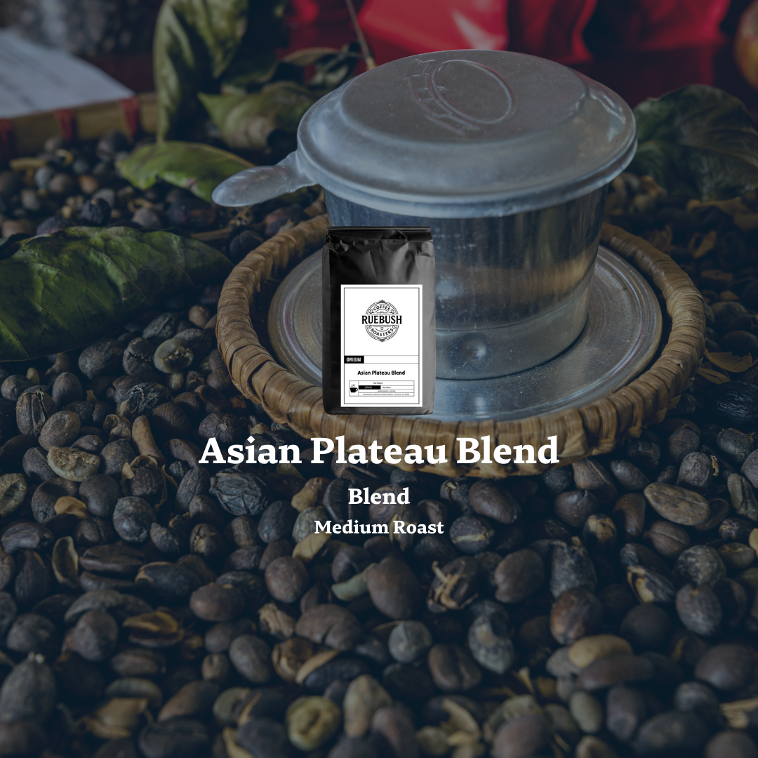 Coffee bag labeled Asian Plateau Blend on coffee beans with a blurred background