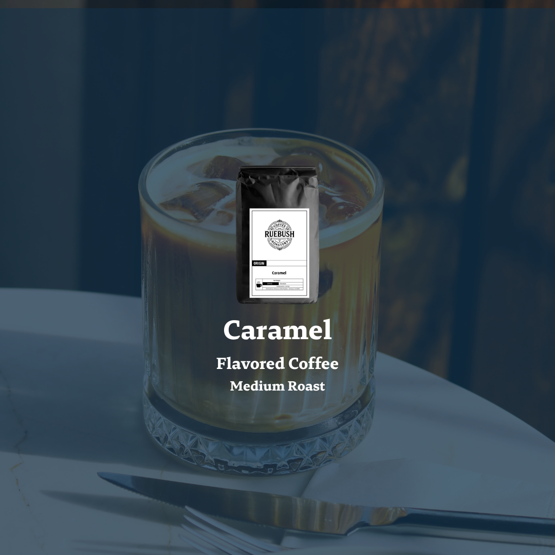 Caramel flavored coffee in a glass with a coffee bag on top, set against a blurred background.