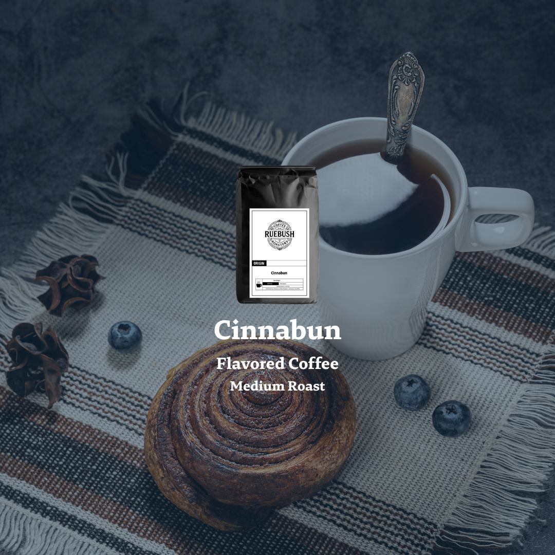 Cinnabun flavored coffee package with a cup of coffee and cinnamon bun on a textured surface