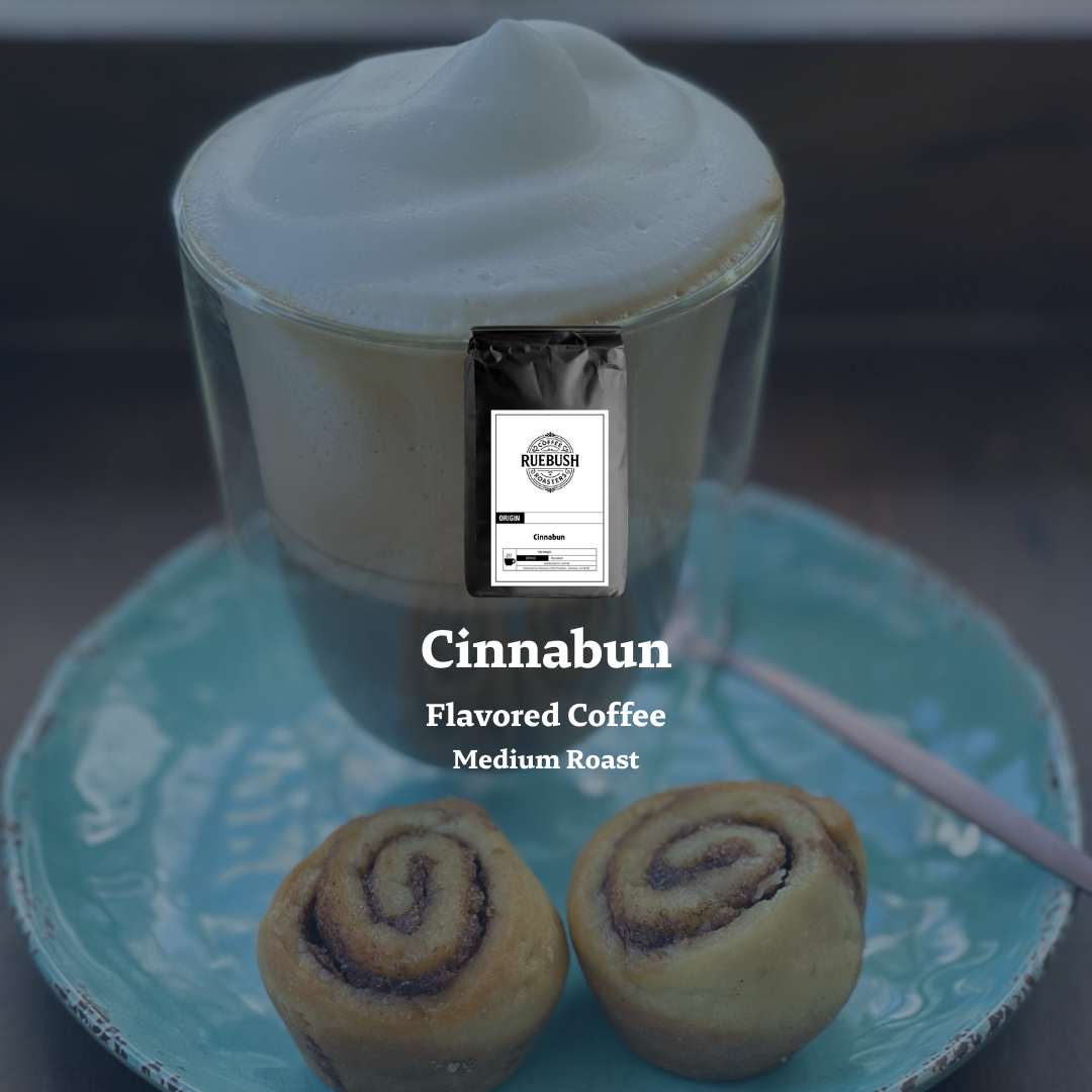 Cinnabun flavored coffee with a cup of coffee and cinnamon rolls on a blue plate