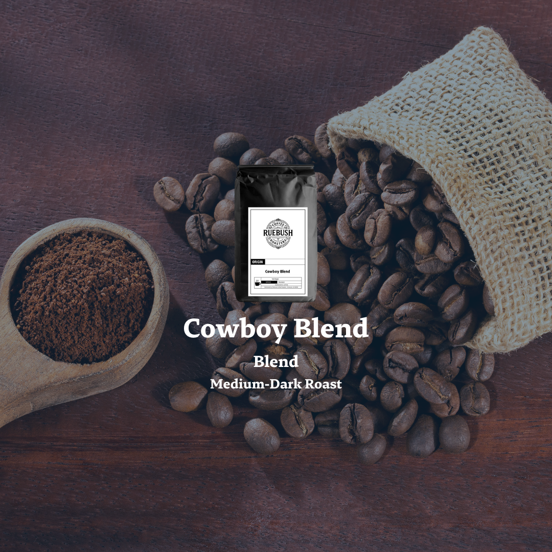 Coffee beans with a bag and scoop on a wooden surface, featuring Cowboy Blend packaging