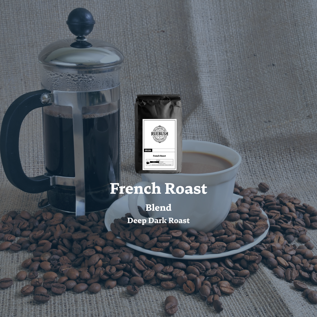 French press, cup of coffee, and coffee beans with a Ruebush Coffee Roasters French Roast package on a textured surface
