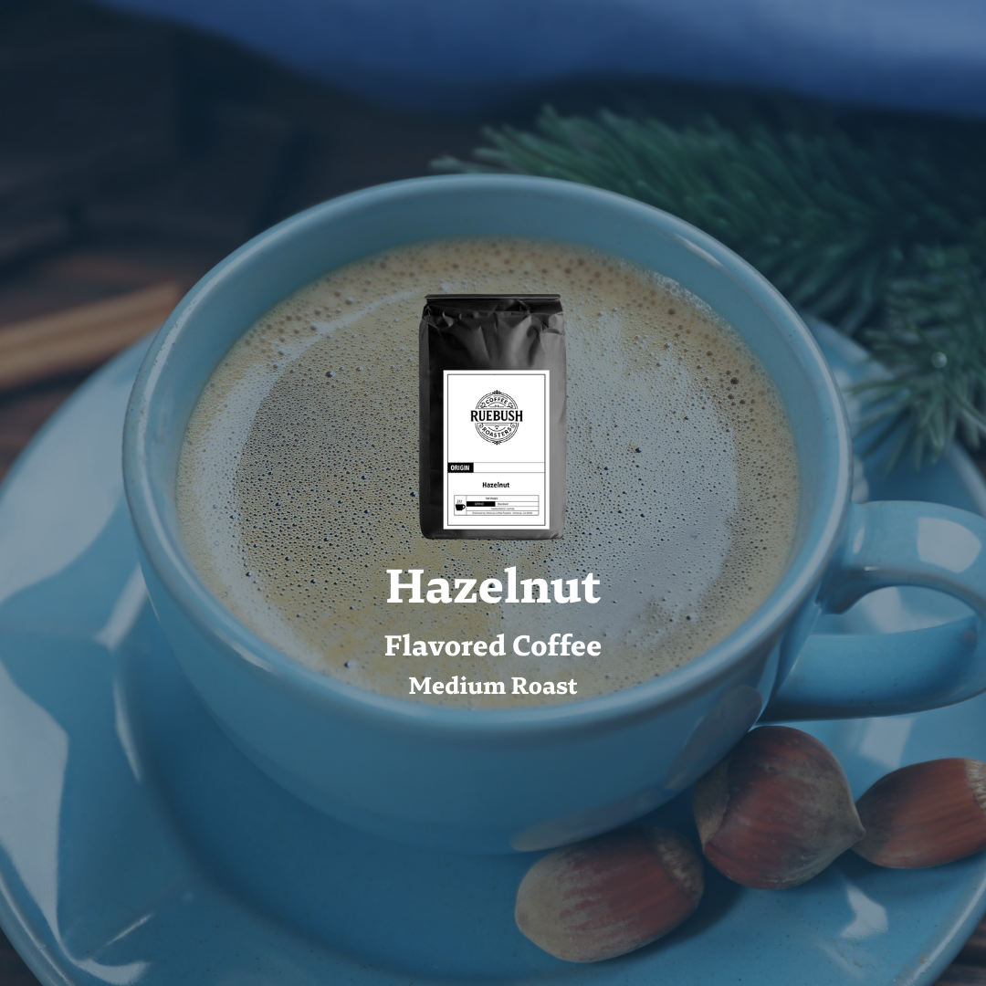 Blue mug with hazelnut flavored coffee on a saucer with coffee beans and greenery
