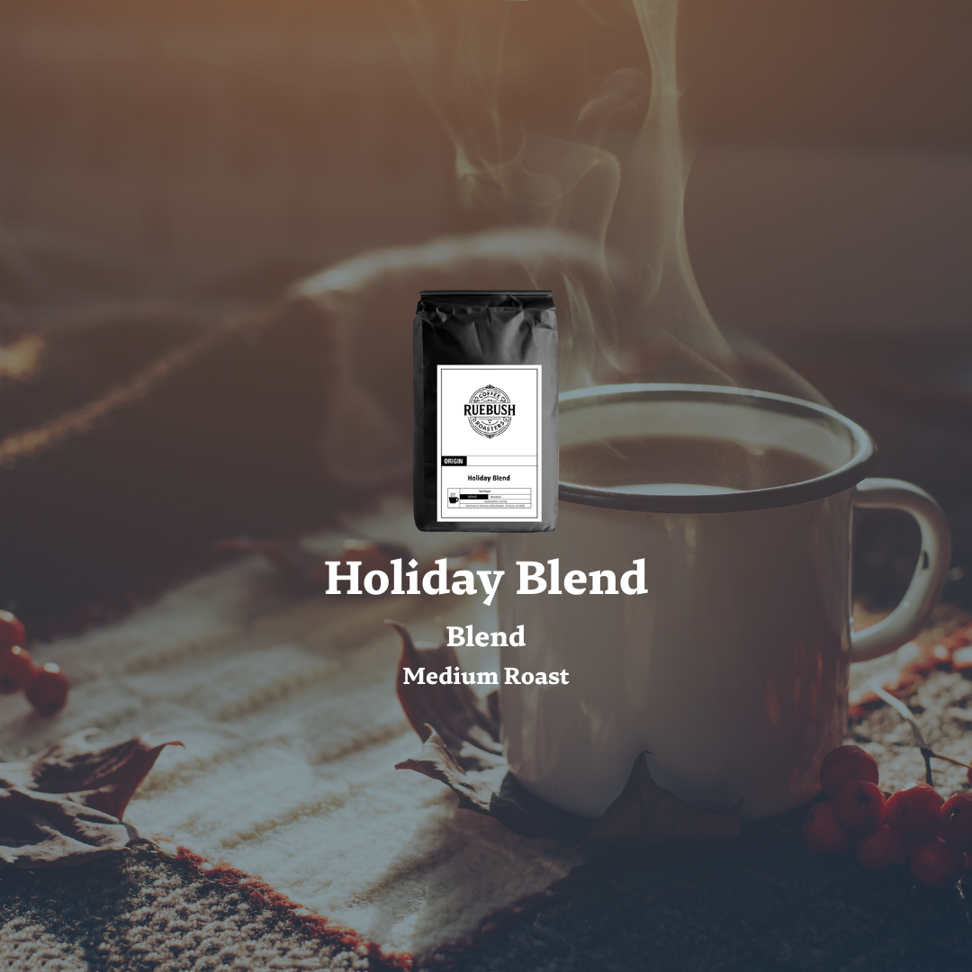 White mug with steaming coffee and a coffee bag labeled Holiday Blend by Ruebush Coffee Roasters on a textured surface.