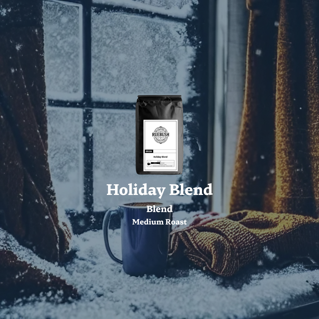 Coffee bag and mug labeled Holiday Blend by Ruebush Coffee Roasters in front of a snowy window