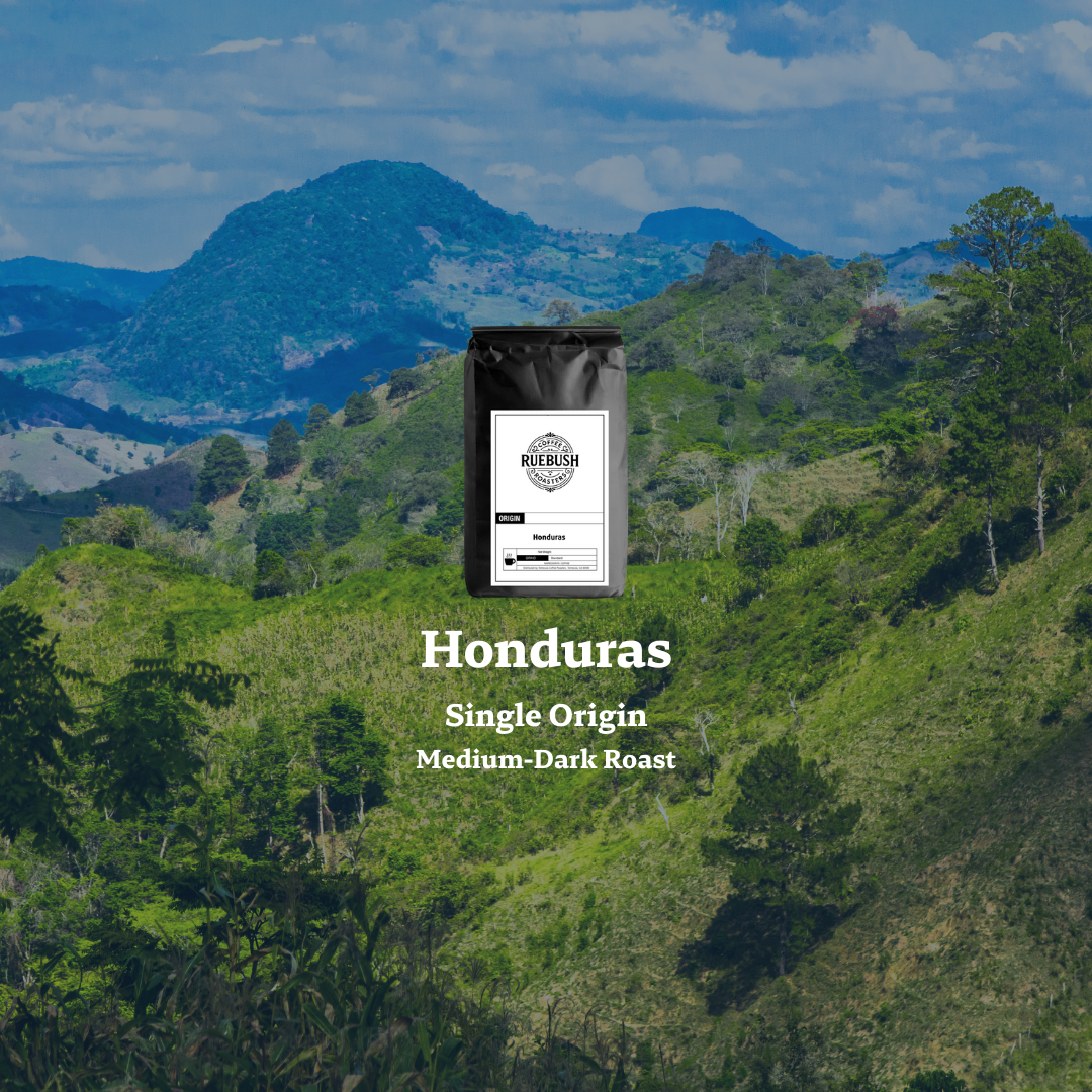Coffee bag labeled Honduras Single Origin Medium-Dark Roast with a scenic background of green hills and mountains