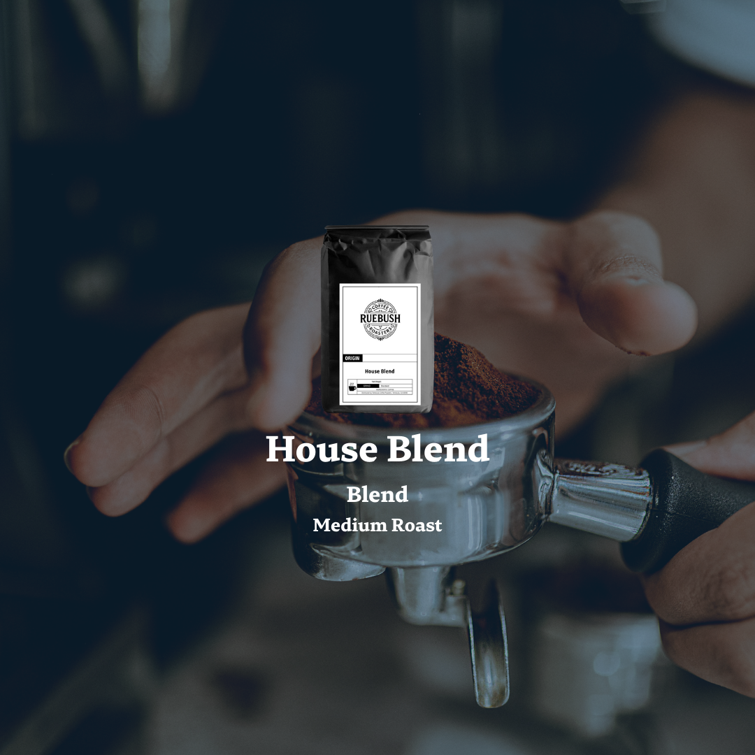 Person holding a coffee grinder with a House Blend label on a blurred background