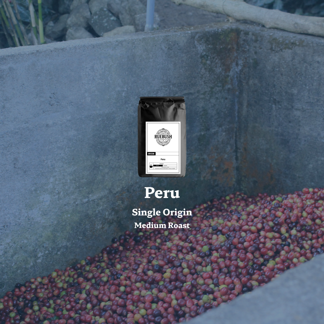 Coffee bag labeled Peru Single Origin Medium Roast on a stone surface with coffee beans