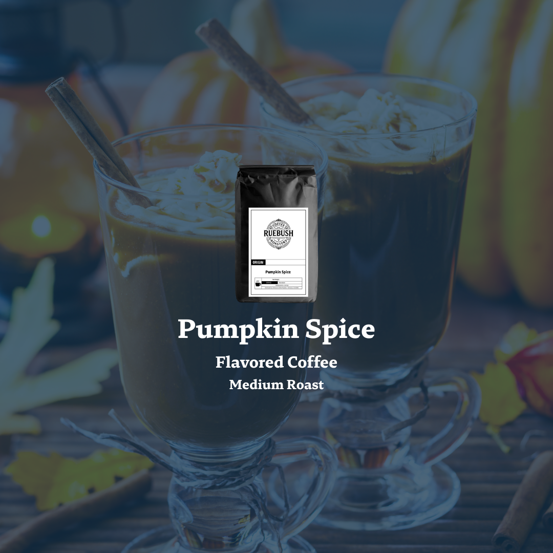Pumpkin spice flavored coffee in a glass with a coffee bag labeled Ruebush Coffee Roasters on a blurred autumn background
