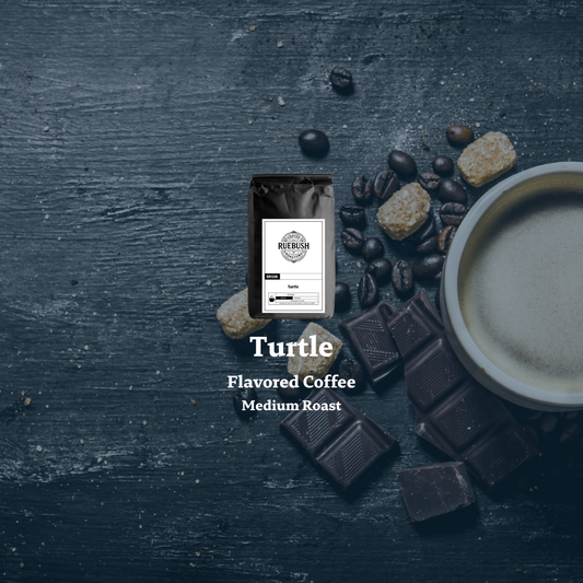 Turtle flavored coffee package with coffee beans, chocolate, and a cup on a dark surface