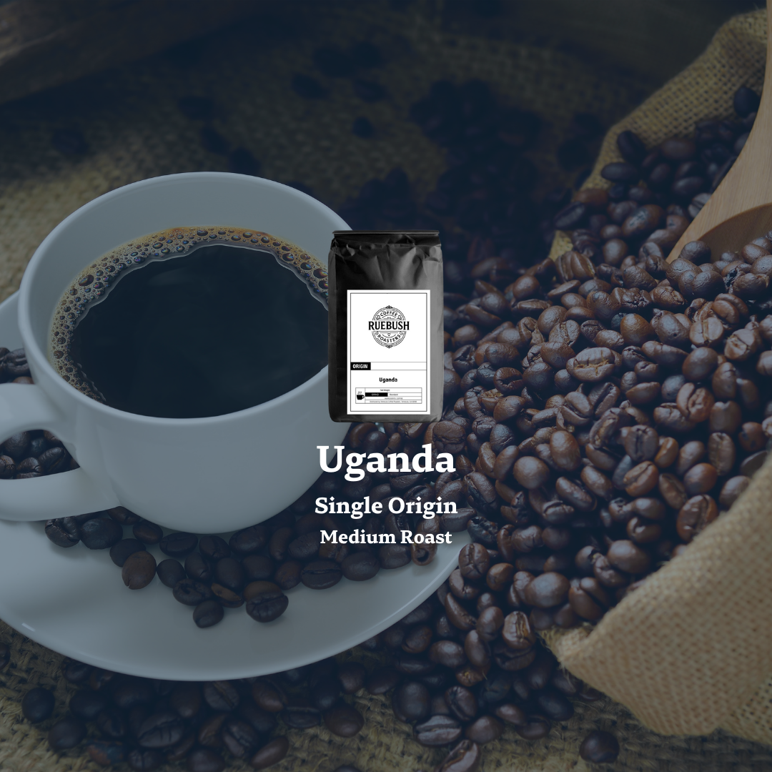 Coffee cup with roasted beans and a bag of coffee labeled Uganda Single Origin Medium Roast