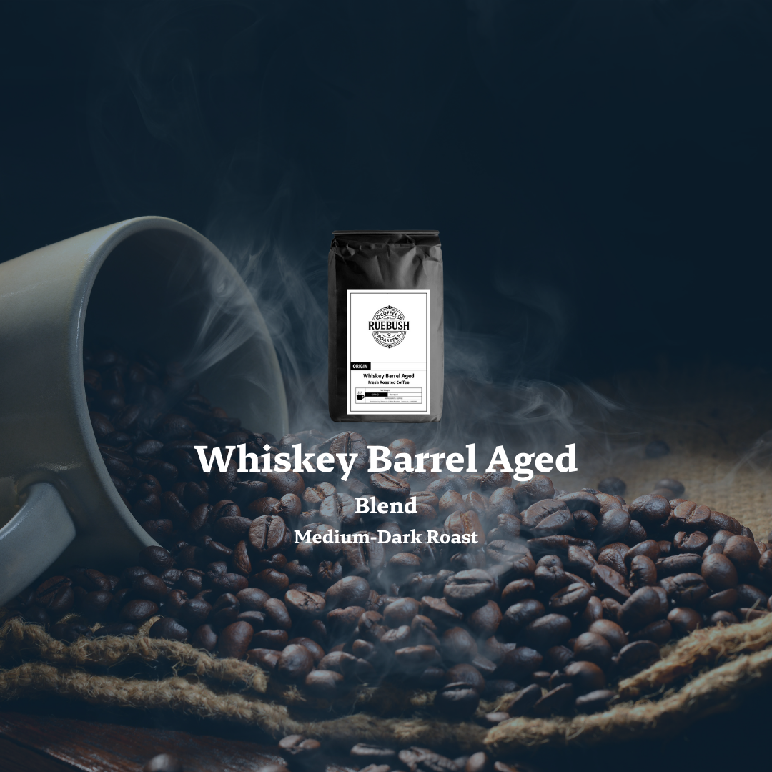 Whiskey Barrel Aged Blend coffee packaging with coffee beans and a cup on a dark background by Ruebush Coffee Roasters