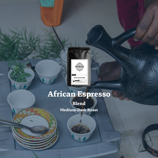 Person pouring coffee into a cup with a Ruebush Coffee Roasters bag labeled African Espresso Blend displayed.