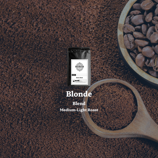 Coffee package labeled Blonde Blend with coffee beans and grounds on a dark brown background