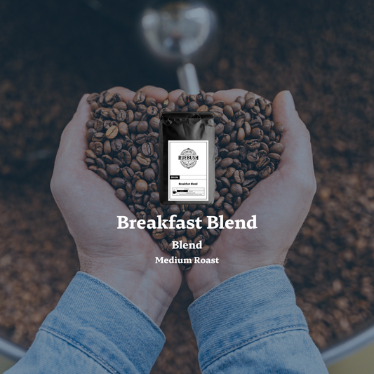 Hands holding coffee beans with a coffee bag labeled Breakfast Blend in the center.
