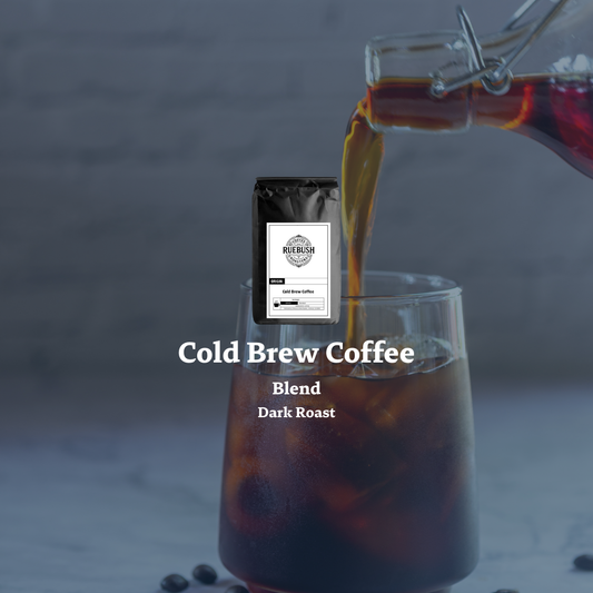Cold brew coffee being poured into a glass with a coffee bag labeled Cold Brew Coffee Blend in the background