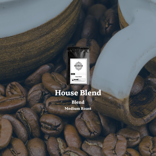 Coffee beans with a coffee bag labeled House Blend by Ruebush Coffee Roasters and Medium Roast