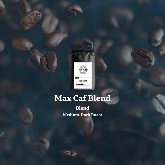Coffee bag labeled Max Caf Blend by Ruebush Coffee Roasters surrounded by coffee beans on a dark background