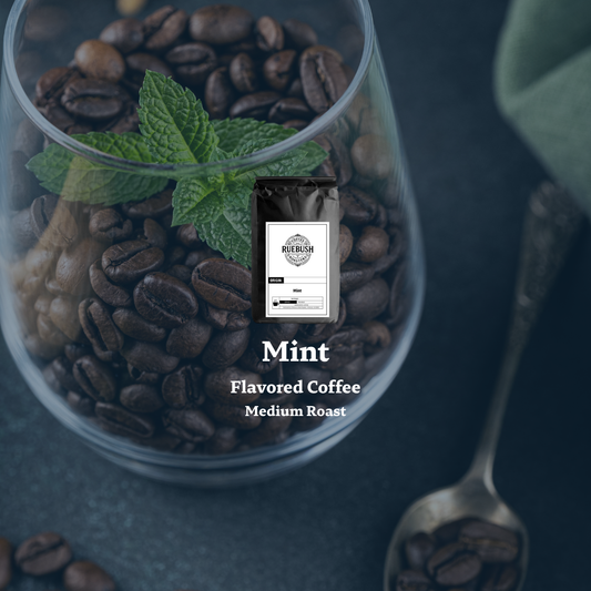 Mint flavored coffee package in a glass with coffee beans and mint leaves on a dark background