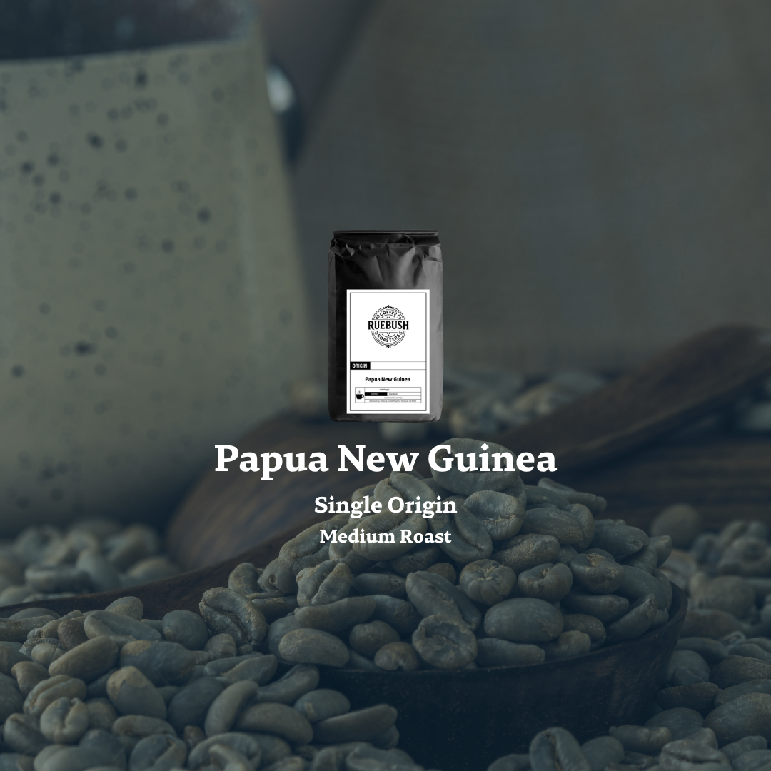 Coffee beans with a coffee bag labeled Papua New Guinea Single Origin Medium Roast on a blurred background.