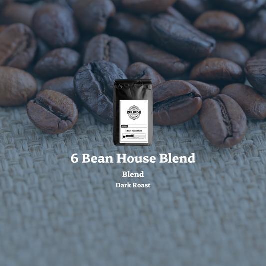 Coffee bag labeled 6 Bean House Blend on a background of coffee beans