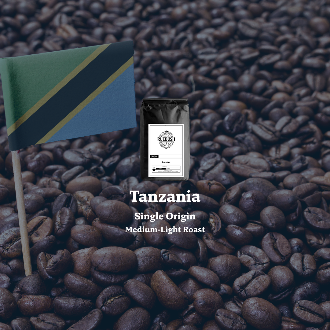 Coffee bag labeled Tanzania Single Origin on a bed of coffee beans with a flag in the background